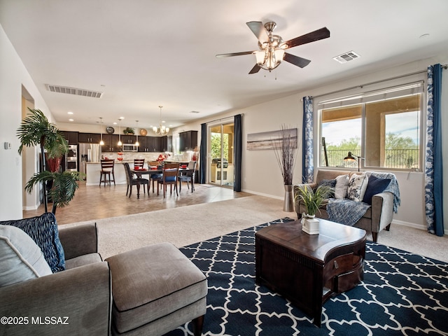 741 S Desert Haven Rd, Vail, AZ 85641 - living area featuring a chandelier, a ceiling fan, baseboards, and light colored carpet