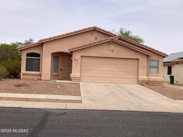 6936 W Sauceda Dr, Tucson, AZ 85743 - mediterranean / spanish-style home featuring driveway, a garage, stucco siding, and a tiled roof