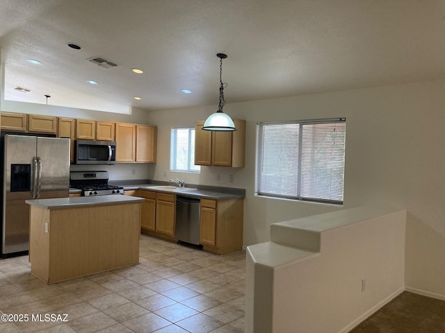 6936 W Sauceda Dr, Tucson, AZ 85743 - kitchen featuring stainless steel appliances, hanging light fixtures, a kitchen island, a sink, and baseboards