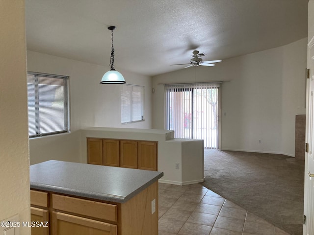 6936 W Sauceda Dr, Tucson, AZ 85743 - kitchen with a ceiling fan, light carpet, open floor plan, light tile patterned floors, and pendant lighting