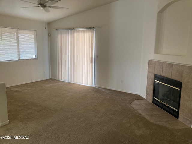 6936 W Sauceda Dr, Tucson, AZ 85743 - unfurnished living room with ceiling fan, carpet floors, a tile fireplace, lofted ceiling, and baseboards