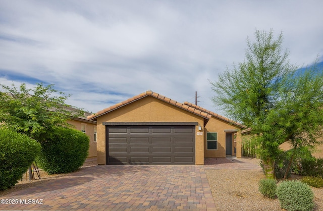 8608 N Genoa Ct, Tucson, AZ 85742 - ranch-style home with an attached garage, stucco siding, decorative driveway, and a tile roof