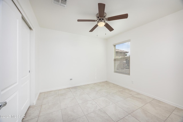 8608 N Genoa Ct, Tucson, AZ 85742 - unfurnished bedroom with a closet, light tile patterned floors, baseboards, and a ceiling fan