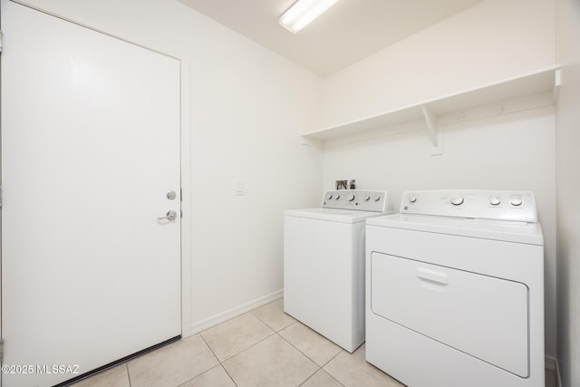 8608 N Genoa Ct, Tucson, AZ 85742 - laundry area with washing machine and dryer, light tile patterned floors, and baseboards
