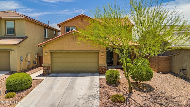 11370 E Creosote Range Dr, Tucson, AZ 85747 - view of front of house with stucco siding, concrete driveway, a garage, a tiled roof, and stone siding