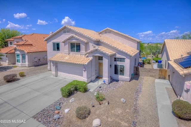 952 S Rincon Rising Rd, Tucson, AZ 85748 - mediterranean / spanish house with stucco siding, a tile roof, concrete driveway, and an attached garage
