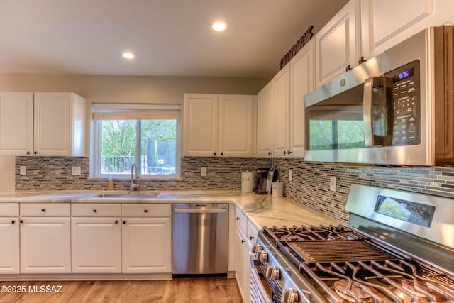 952 S Rincon Rising Rd, Tucson, AZ 85748 - kitchen with stainless steel appliances, a sink, white cabinetry, backsplash, and recessed lighting
