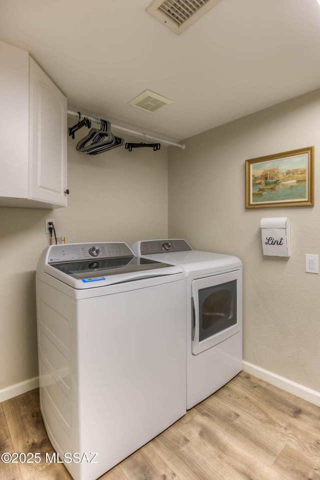 952 S Rincon Rising Rd, Tucson, AZ 85748 - laundry area with cabinet space, independent washer and dryer, light wood-style floors, and baseboards