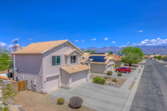 952 S Rincon Rising Rd, Tucson, AZ 85748 - mediterranean / spanish home featuring a mountain view, stucco siding, a tiled roof, and a garage