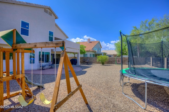 952 S Rincon Rising Rd, Tucson, AZ 85748 - view of play area featuring a trampoline, a patio area, and a fenced backyard