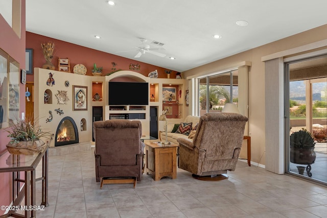 65535 E Rose Ridge Dr, Saddlebrooke, AZ 85739 - living room featuring a tiled fireplace, vaulted ceiling, ceiling fan, plenty of natural light, and recessed lighting