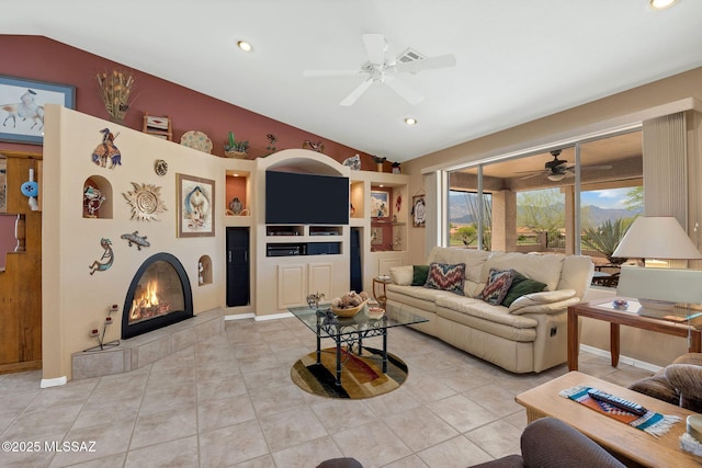 65535 E Rose Ridge Dr, Saddlebrooke, AZ 85739 - living area with vaulted ceiling, ceiling fan, light tile patterned flooring, a tile fireplace, and recessed lighting