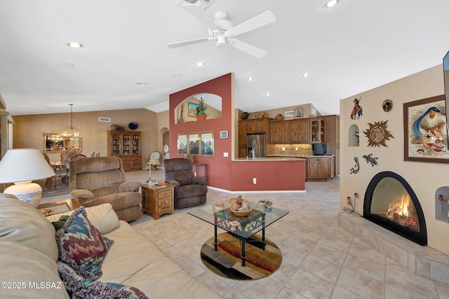 65535 E Rose Ridge Dr, Saddlebrooke, AZ 85739 - living area with vaulted ceiling, light tile patterned floors, a chandelier, a ceiling fan, and a fireplace