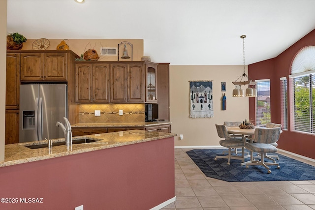 65535 E Rose Ridge Dr, Saddlebrooke, AZ 85739 - kitchen featuring stainless steel fridge, a sink, decorative backsplash, light tile patterned floors, and light stone counters