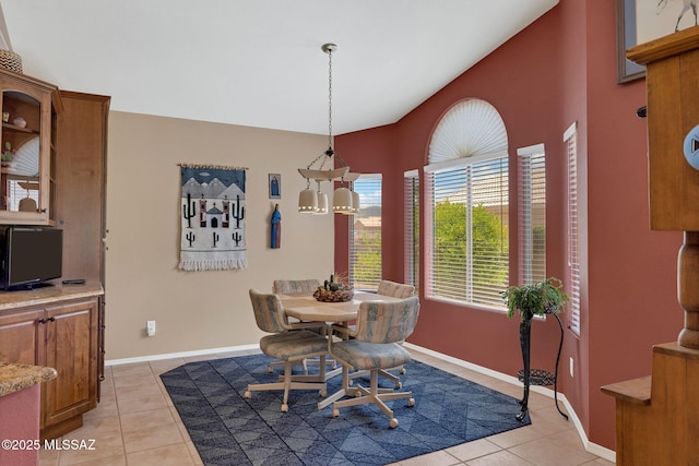 65535 E Rose Ridge Dr, Saddlebrooke, AZ 85739 - dining space featuring vaulted ceiling, light tile patterned floors, and baseboards