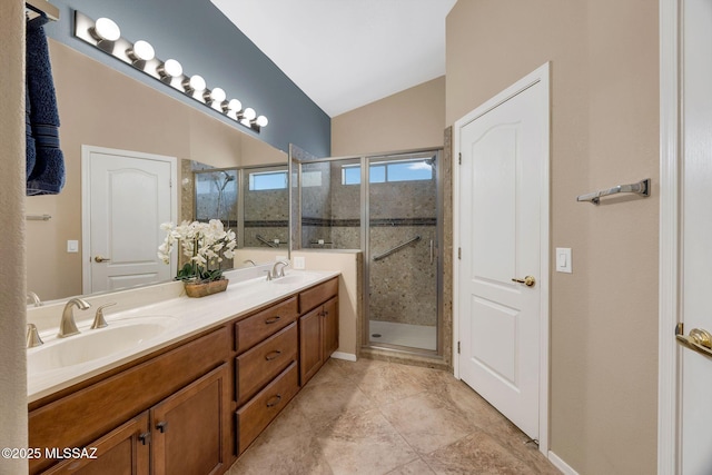 65535 E Rose Ridge Dr, Saddlebrooke, AZ 85739 - bathroom featuring vaulted ceiling, double vanity, a shower stall, and tile patterned floors