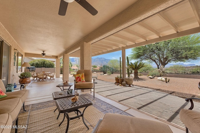 65535 E Rose Ridge Dr, Saddlebrooke, AZ 85739 - fenced backyard featuring a ceiling fan, a patio, outdoor dining space, and outdoor lounge area