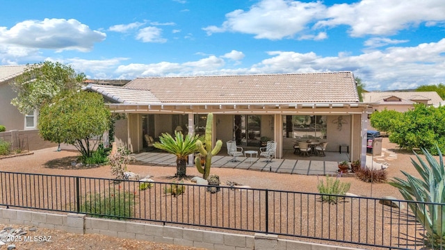 65535 E Rose Ridge Dr, Saddlebrooke, AZ 85739 - rear view of property with a tile roof, a fenced backyard, stucco siding, and a patio area