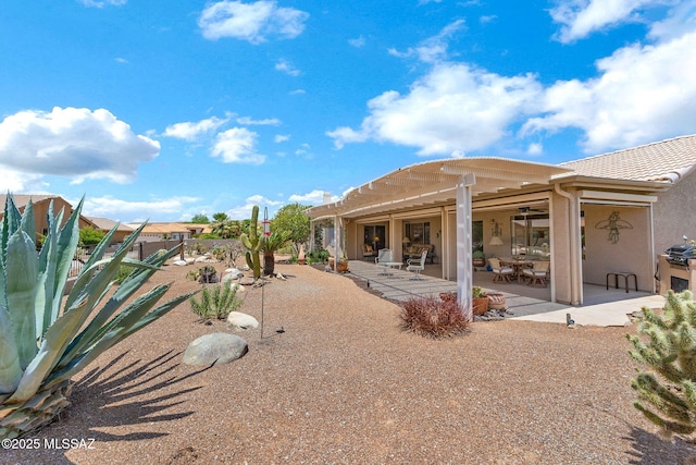 65535 E Rose Ridge Dr, Saddlebrooke, AZ 85739 - back of house featuring a patio area, stucco siding, and a ceiling fan