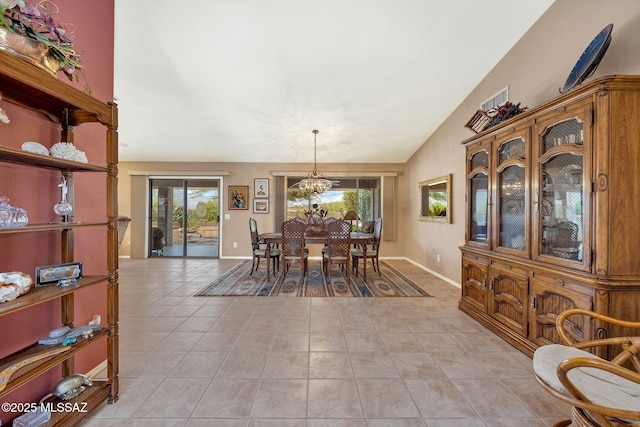 65535 E Rose Ridge Dr, Saddlebrooke, AZ 85739 - dining room with light tile patterned floors, healthy amount of natural light, a chandelier, baseboards, and vaulted ceiling