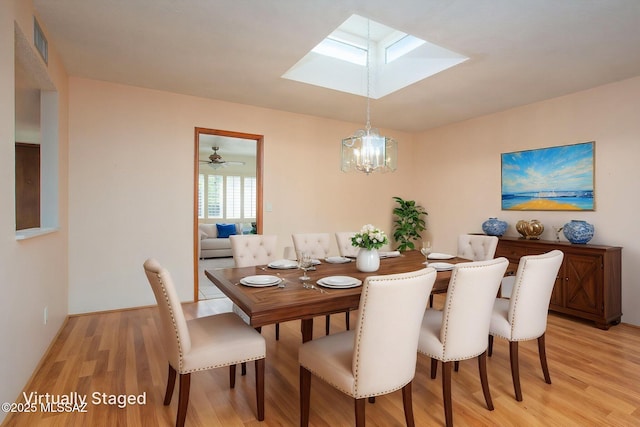 4736 N Calle Lampara, Tucson, AZ 85718 - dining room with a skylight, light wood-style floors, and a chandelier
