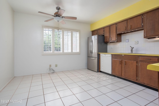 4736 N Calle Lampara, Tucson, AZ 85718 - kitchen featuring white dishwasher, freestanding refrigerator, ceiling fan, a sink, and tasteful backsplash