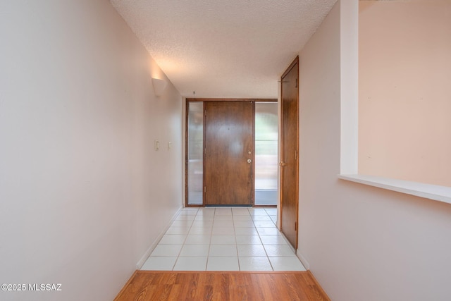 4736 N Calle Lampara, Tucson, AZ 85718 - hallway featuring a textured ceiling, baseboards, and light tile patterned floors