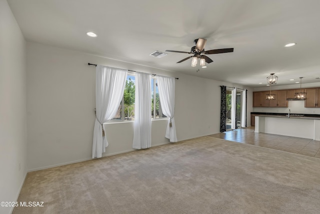 9569 N Sage Vista Ct, Tucson, AZ 85742 - unfurnished living room with recessed lighting, a ceiling fan, light colored carpet, and baseboards