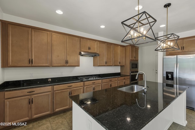 9569 N Sage Vista Ct, Tucson, AZ 85742 - kitchen with under cabinet range hood, stainless steel appliances, a sink, recessed lighting, and brown cabinetry