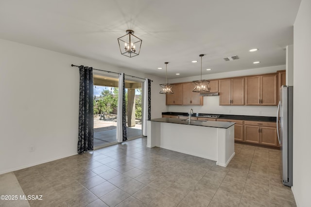 9569 N Sage Vista Ct, Tucson, AZ 85742 - kitchen with dark countertops, freestanding refrigerator, a sink, recessed lighting, and a chandelier
