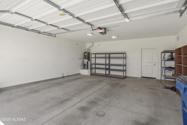 9569 N Sage Vista Ct, Tucson, AZ 85742 - garage with gas water heater, a garage door opener, and baseboards