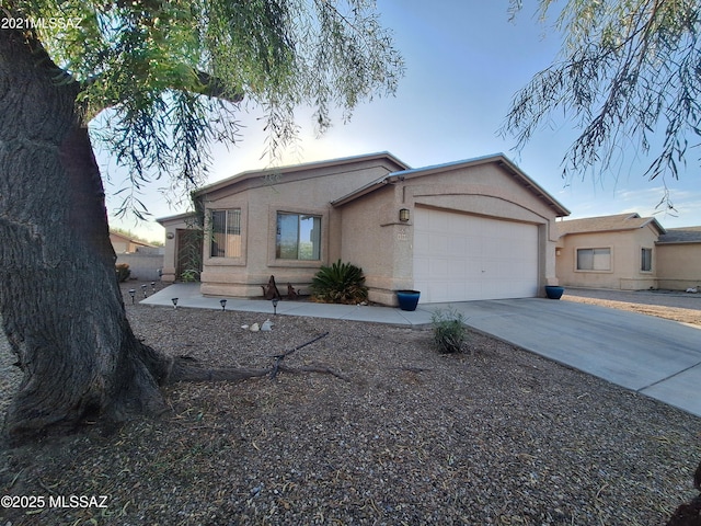 4396 S Valley Rd, Tucson, AZ 85714 - view of front of house with concrete driveway, stucco siding, and an attached garage