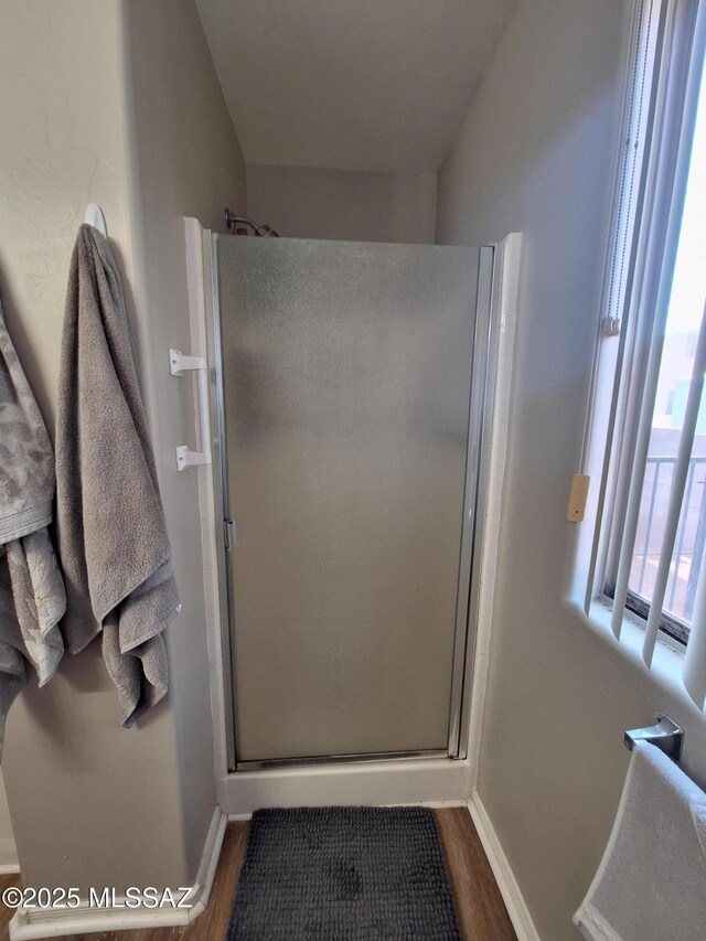 4396 S Valley Rd, Tucson, AZ 85714 - full bathroom featuring a stall shower, wood finished floors, and baseboards