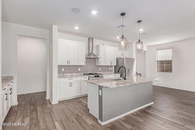 16800 S Paseo Las Vigas, Sahuarita, AZ 85629 - kitchen with a sink, wall chimney exhaust hood, appliances with stainless steel finishes, light wood-style floors, and recessed lighting