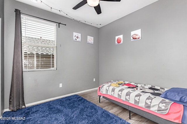 16800 S Paseo Las Vigas, Sahuarita, AZ 85629 - bedroom featuring wood finished floors, a ceiling fan, and baseboards