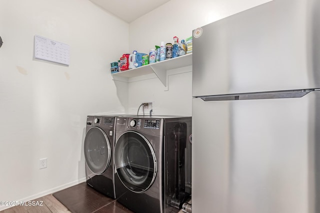 16800 S Paseo Las Vigas, Sahuarita, AZ 85629 - washroom featuring washing machine and dryer, wood finished floors, and baseboards