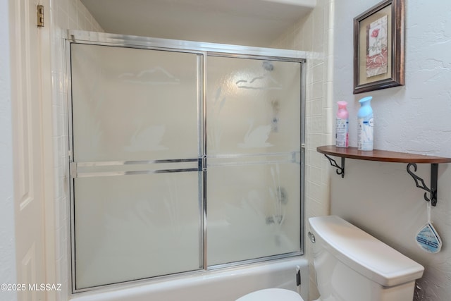 5457 S 13th Ave, Tucson, AZ 85706 - bathroom featuring toilet, bath / shower combo with glass door, and a textured wall