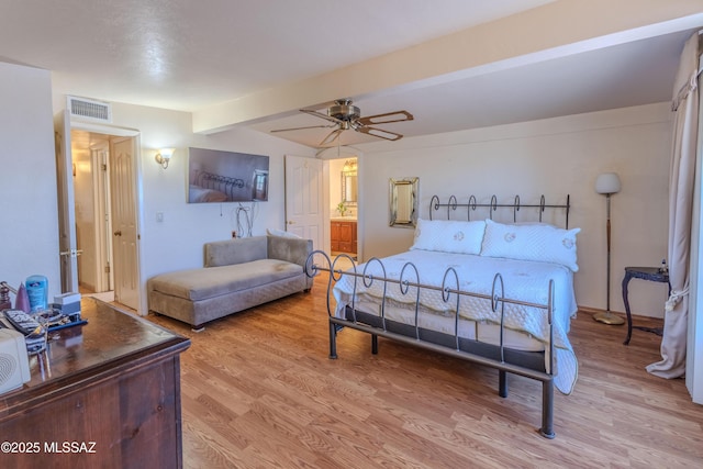 5457 S 13th Ave, Tucson, AZ 85706 - bedroom with light wood finished floors, beam ceiling, a ceiling fan, and ensuite bath