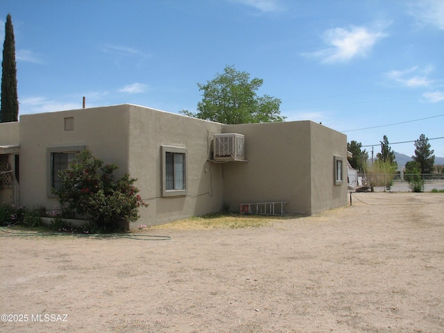 277 N Bowie Ave, Willcox, AZ 85643 - back of house with stucco siding and an AC wall unit