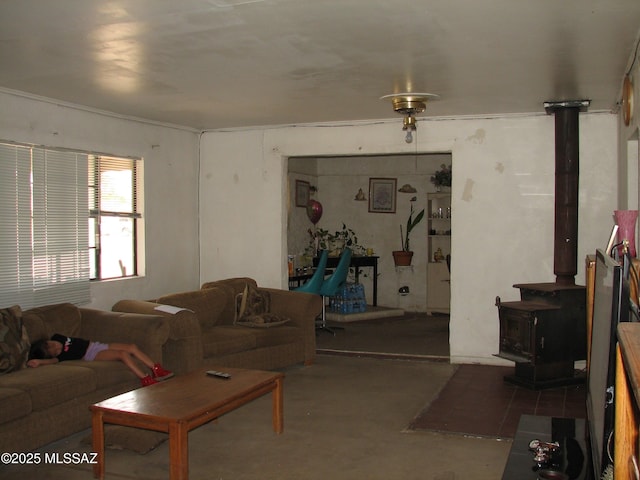 277 N Bowie Ave, Willcox, AZ 85643 - living room featuring a wood stove and concrete flooring