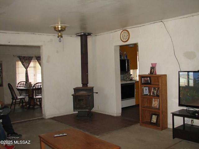 277 N Bowie Ave, Willcox, AZ 85643 - living room with concrete flooring and a wood stove