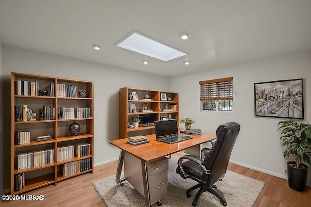 8069 E Cameo Cir, Tucson, AZ 85750 - home office featuring a skylight, light wood-style floors, and baseboards