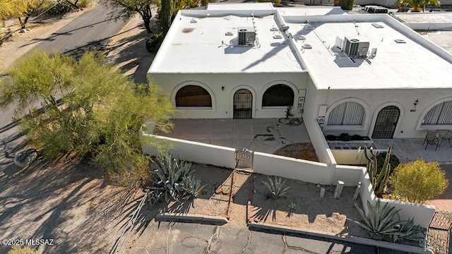 8069 E Cameo Cir, Tucson, AZ 85750 - back of property with a fenced front yard, stucco siding, and central AC