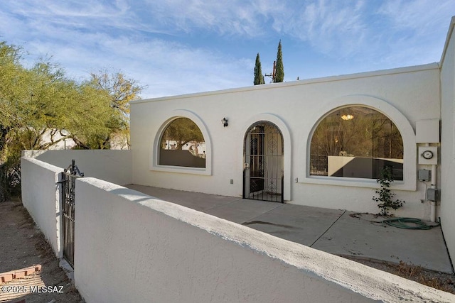8069 E Cameo Cir, Tucson, AZ 85750 - property entrance featuring stucco siding and a gate
