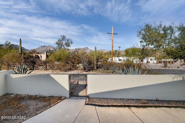 8069 E Cameo Cir, Tucson, AZ 85750 - exterior space featuring a fenced front yard, a gate, and a mountain view