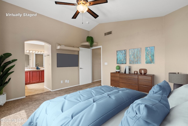 6783 W Alegria Dr, Tucson, AZ 85743 - bedroom featuring light colored carpet, high vaulted ceiling, arched walkways, baseboards, and connected bathroom