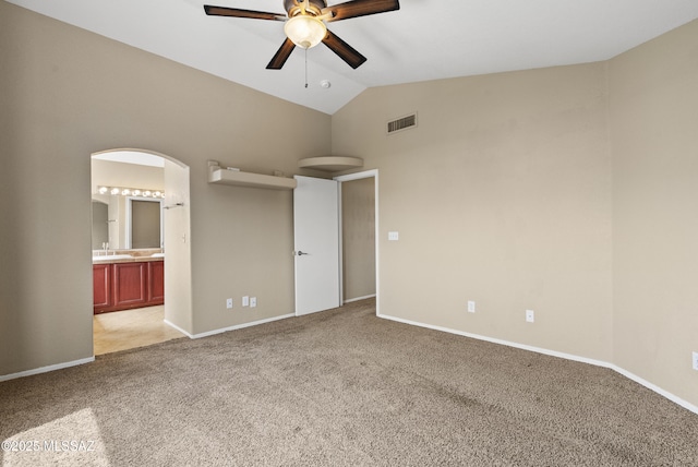 6783 W Alegria Dr, Tucson, AZ 85743 - spare room featuring a ceiling fan, light colored carpet, arched walkways, high vaulted ceiling, and baseboards