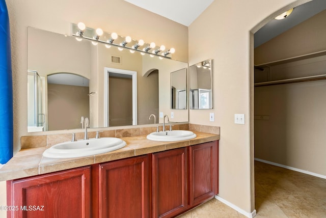 6783 W Alegria Dr, Tucson, AZ 85743 - bathroom featuring double vanity and a spacious closet