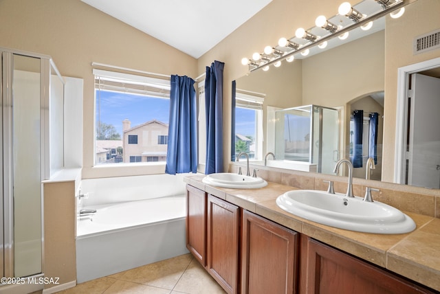 6783 W Alegria Dr, Tucson, AZ 85743 - bathroom featuring a shower stall, lofted ceiling, double vanity, a bath, and tile patterned flooring