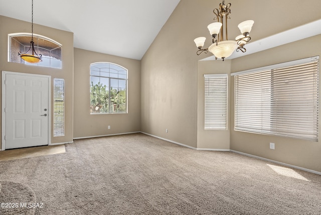 6783 W Alegria Dr, Tucson, AZ 85743 - entryway with a chandelier, high vaulted ceiling, carpet floors, and baseboards
